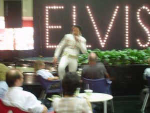 an Elvis impersonator in Singapore airport. Sorry that it's so blurry; it generally doesn't even occur to me to take pictures in airports, so I have very few to choose from. (He was particularly bad, by the way.)