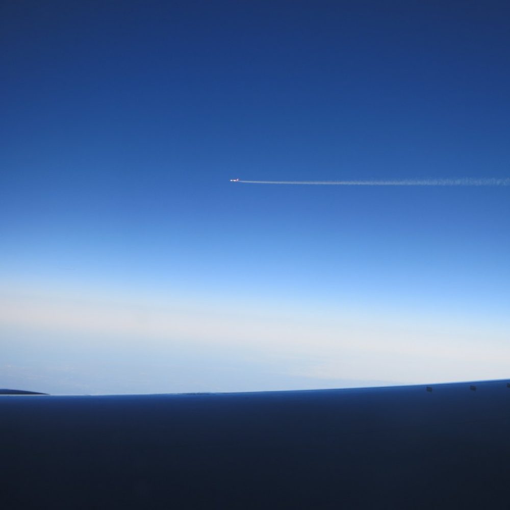 a picture of a plane, taken from a plane; is flying safe?