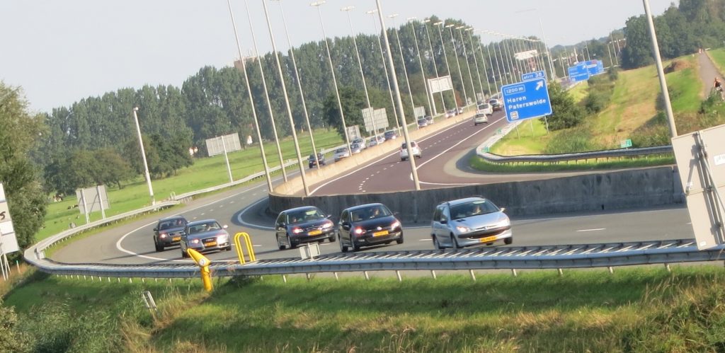 a view over a highway with a few cars passing by