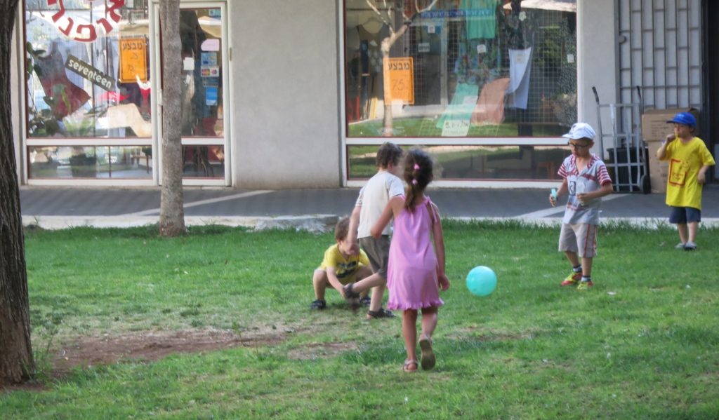 children at play at a Jerusalem shopping center: life here seems to be going on as usual, but there's certainly tension in the air