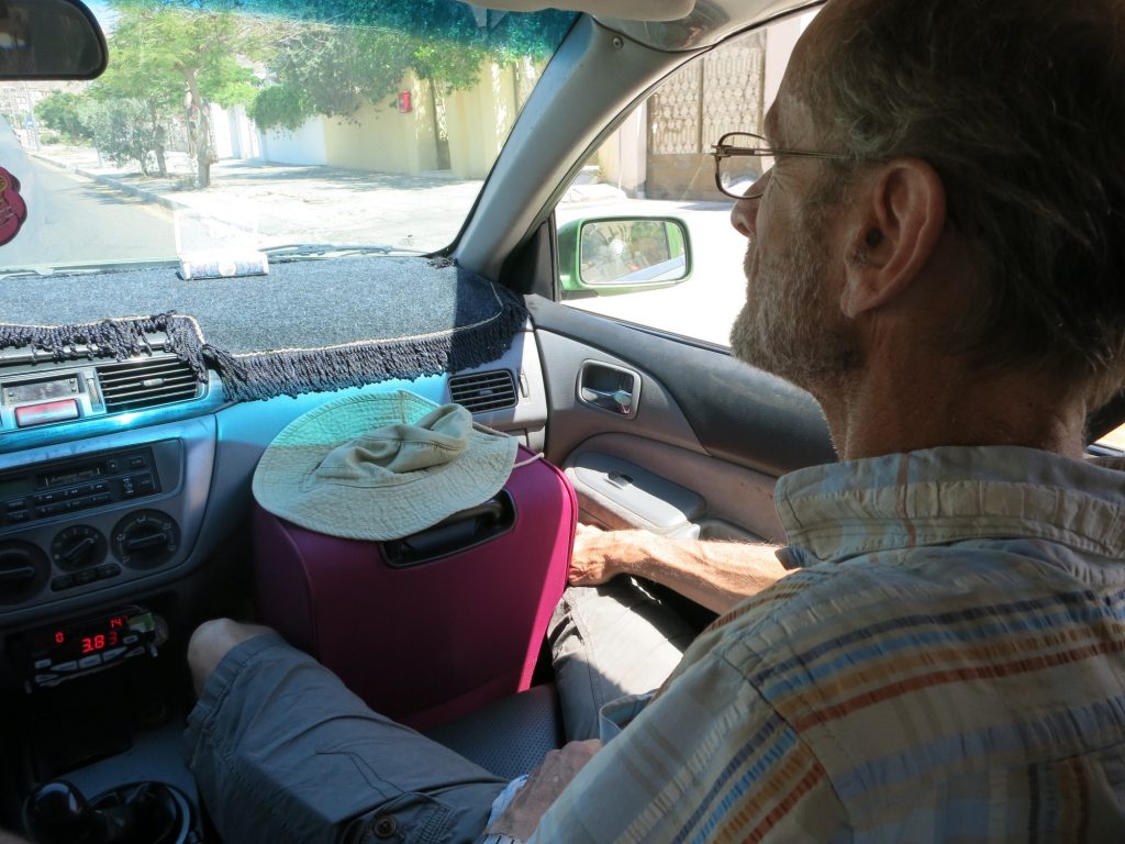 the suitcase jammed in the front seat with Albert