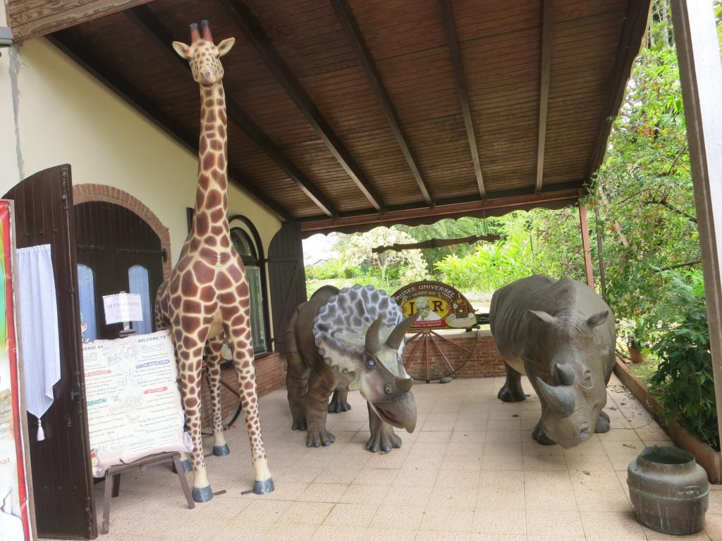 life-sized models of a giraffe, a triceratops and a rhino outside the Rum Museum