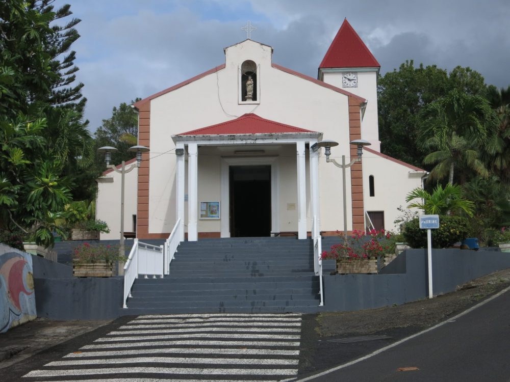 a view of the church in Deshaies, visible in many scenes in Death in Paradise.