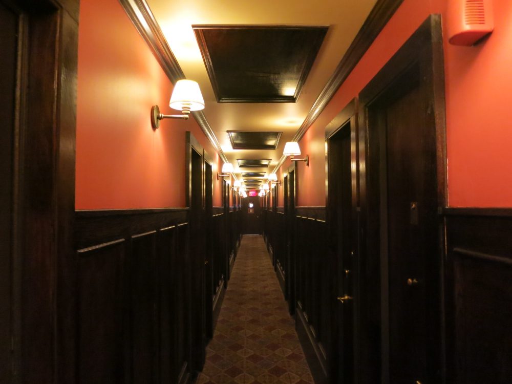 a view down a hallway in the Jane Hotel, very much resembling a ship's hallway