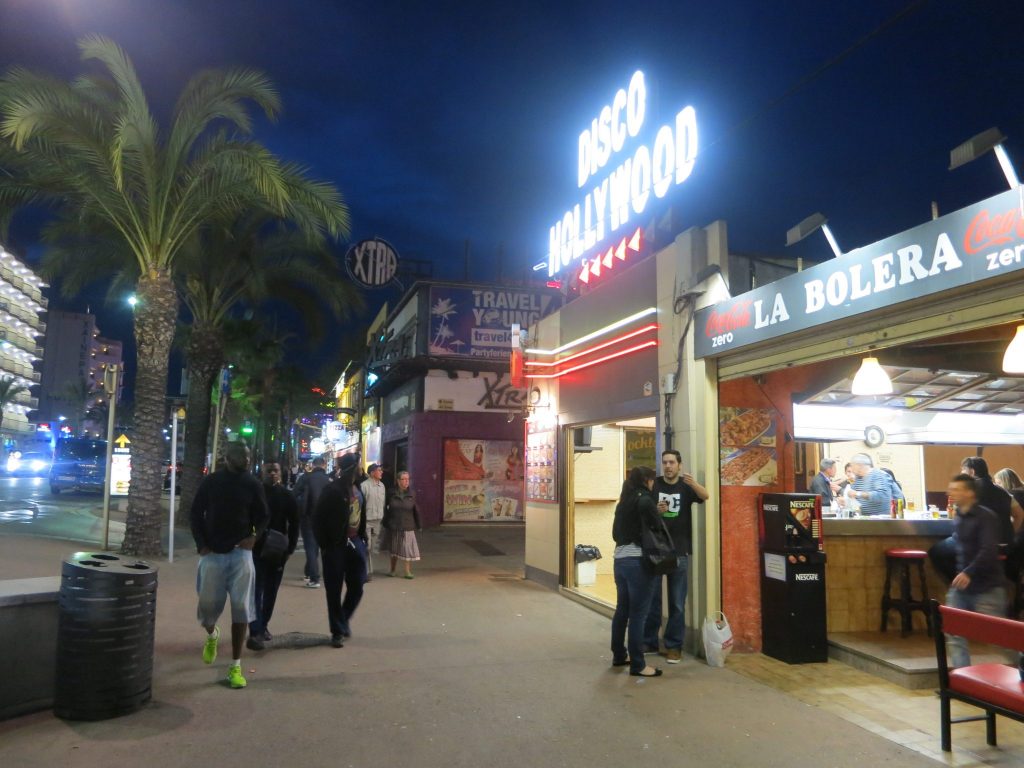 neon-lit fast-food restaurant storefronts in Lloret de Mar