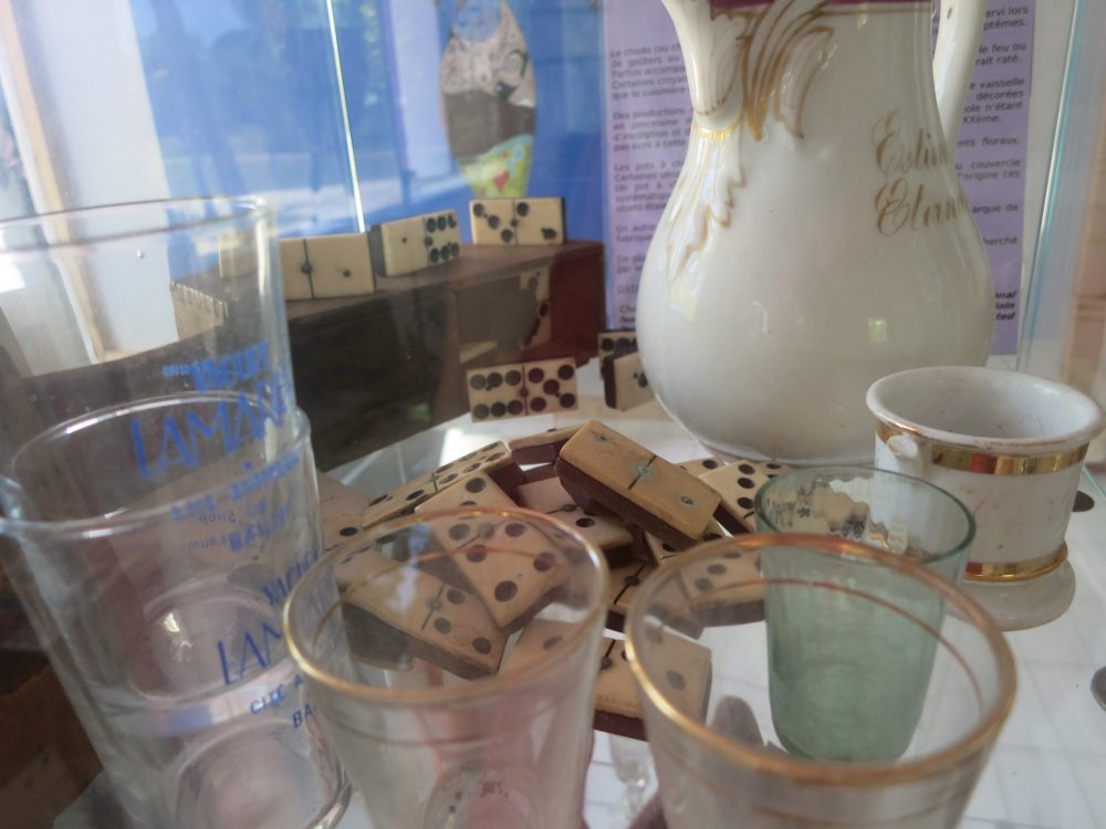 dominoes, glasses and other small items from the colonial period on display at Kreol West Indies