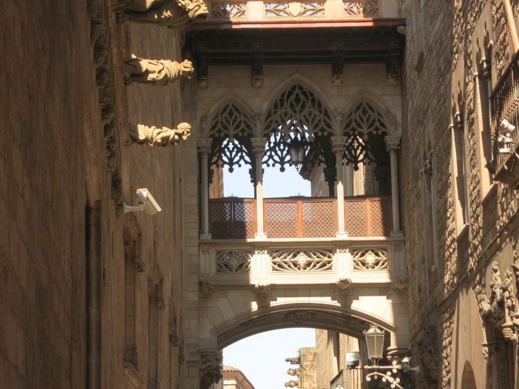 supposedly medieval bridge over the street, with gargoyles