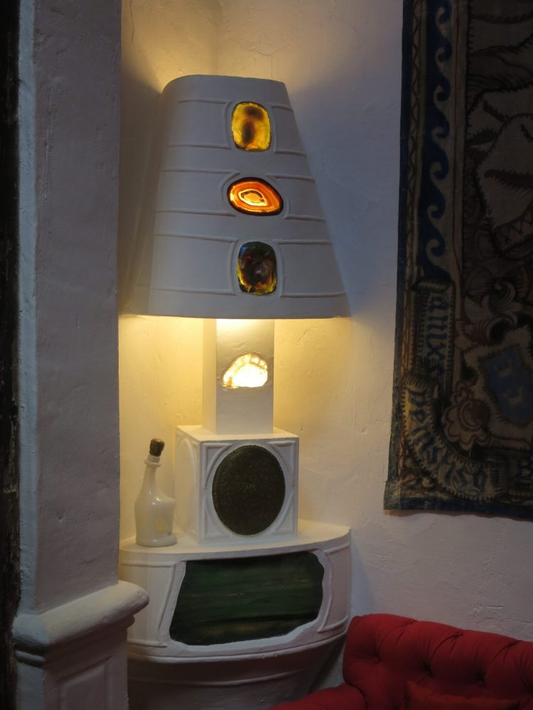 The lamp is attached to the table and has cutouts with something like geodes in it.