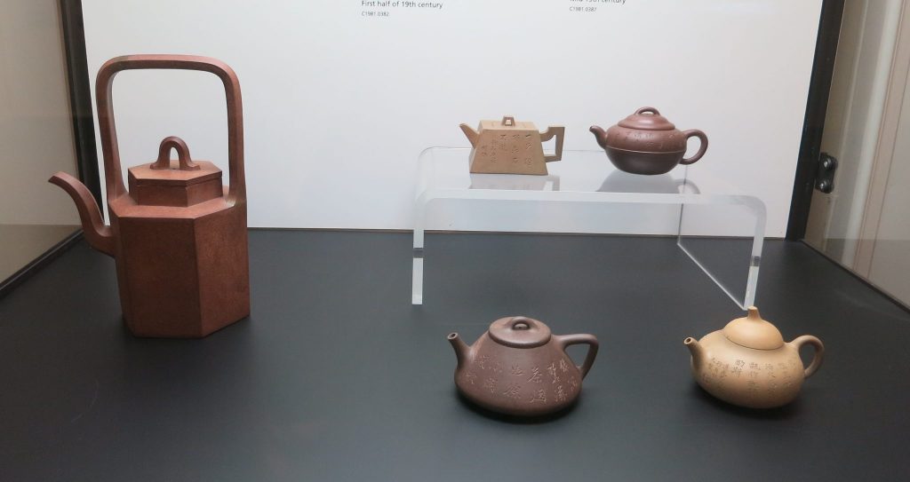 a display case with 5 teapots, in the Tea Ware Museum in Hong Kong Park