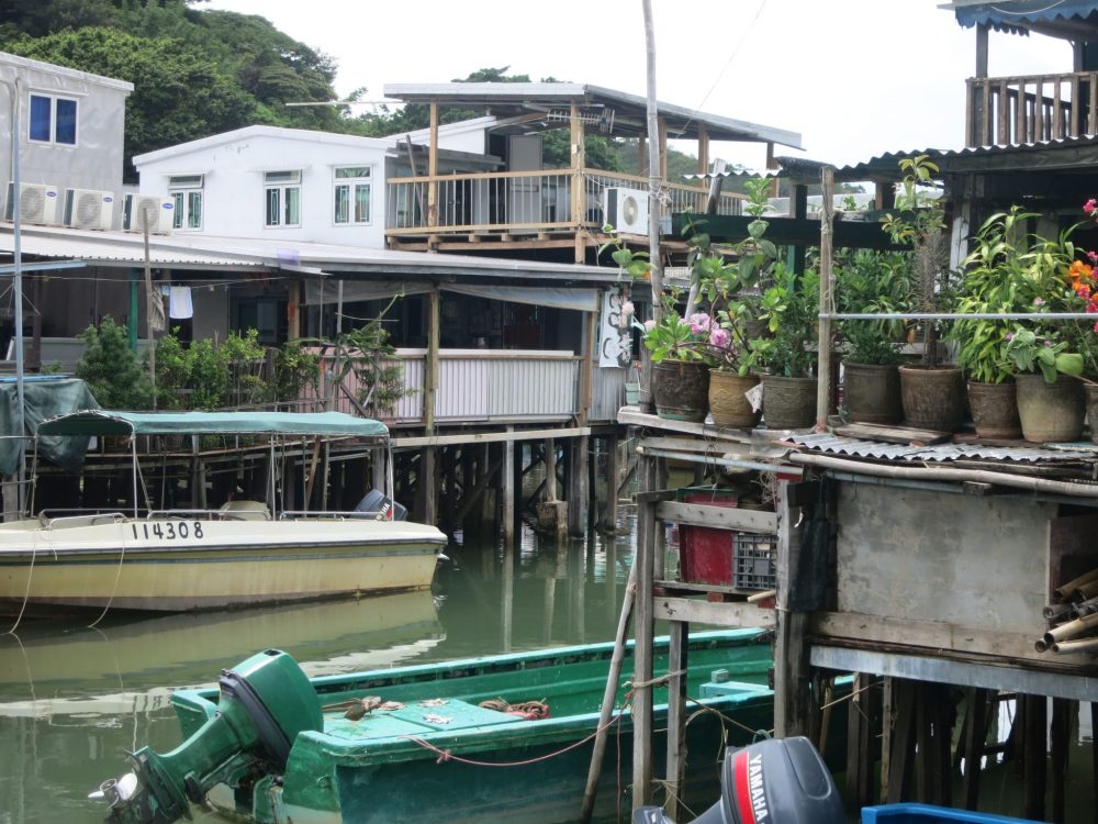 scene of jumbled houses, with boats moored outside them, in Tai O