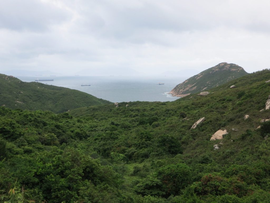 a view over green hills and sea, on Lamma Island