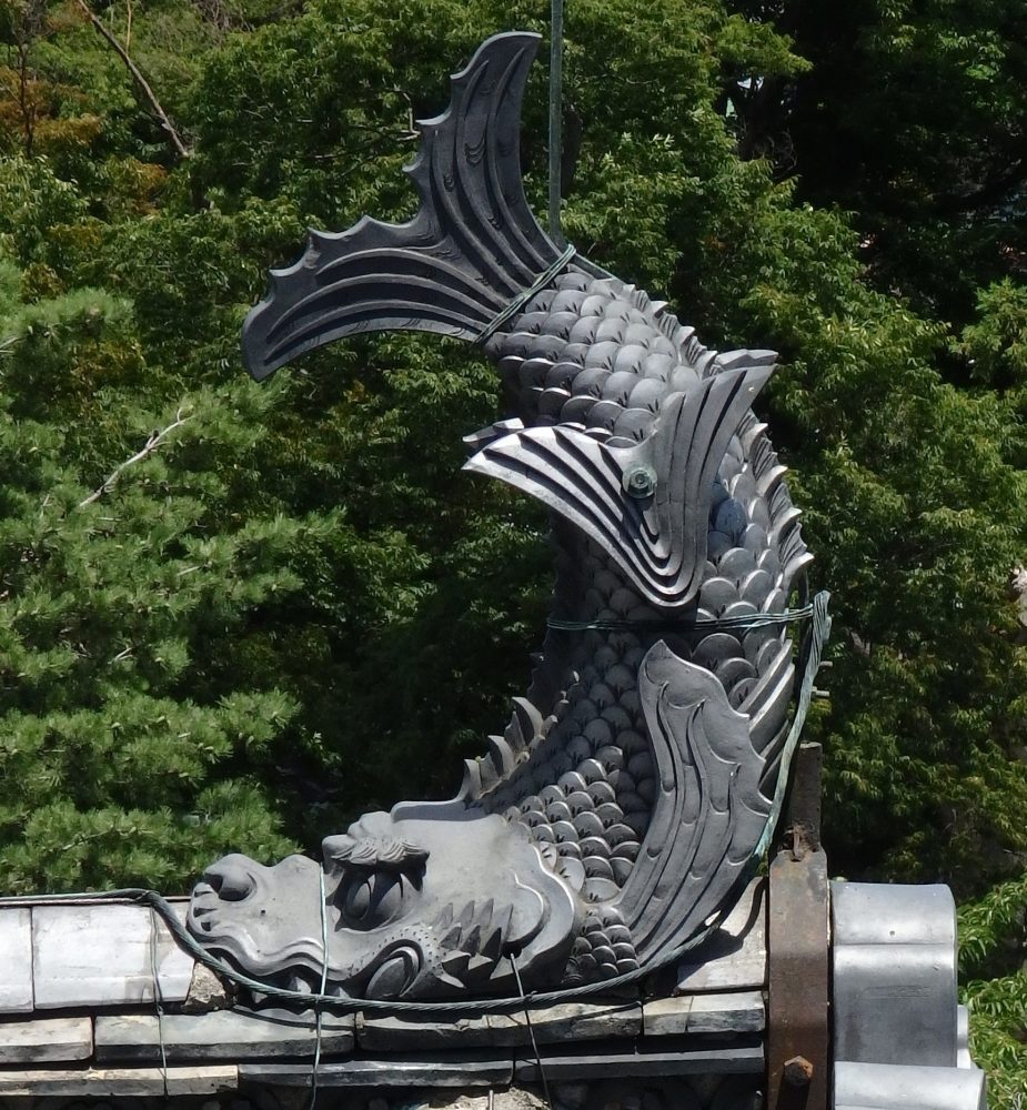 The form of a fish decorates each peak of the roof of Matsumoto Castle.