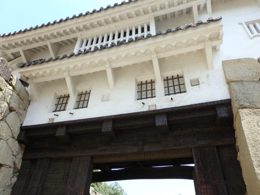 One of the gates to Himeji Castle, with heavy wooden supports and barred windows.