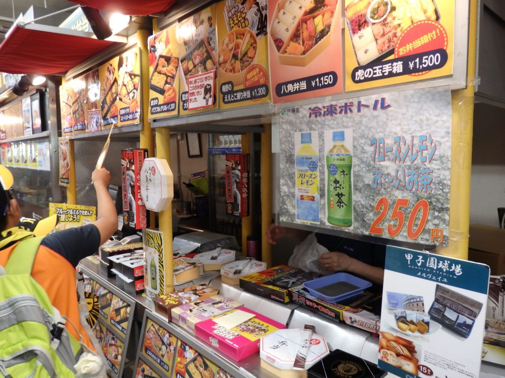 a food stand in the baseball stadium selling bento boxes