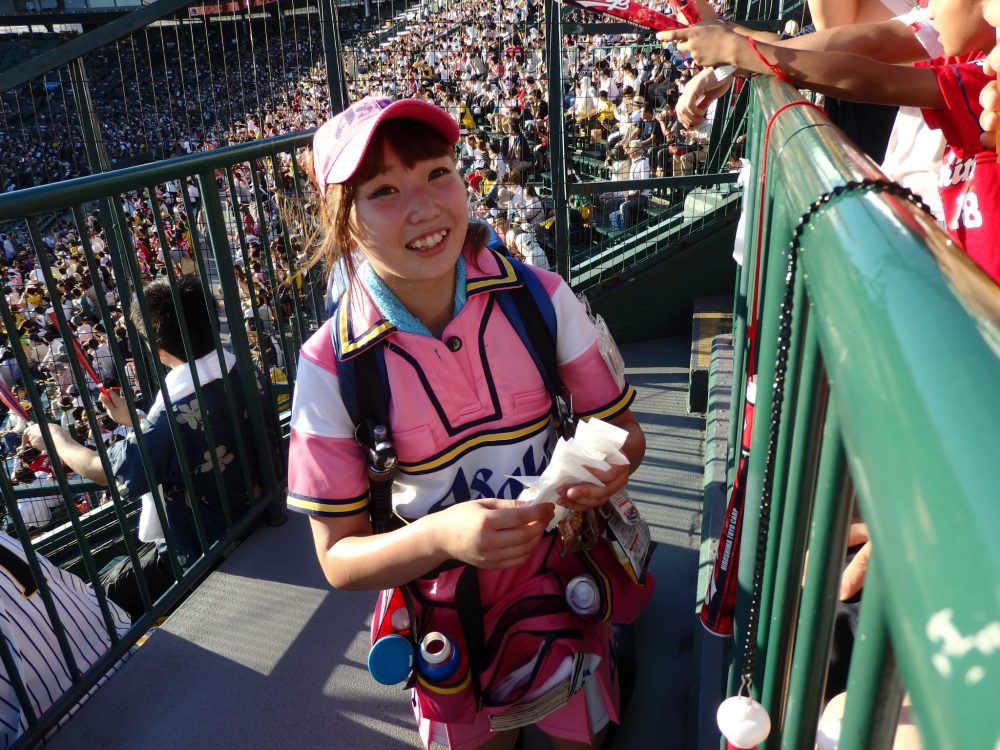 a bear hawker selling beer at the baseball game between the Hanshin Tigers and the Hiroshima Carp