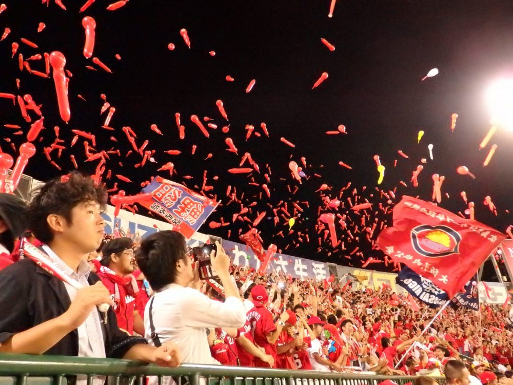 Supporters of the Hiroshima Carp release whistling balloons at the top of the 7th inning.