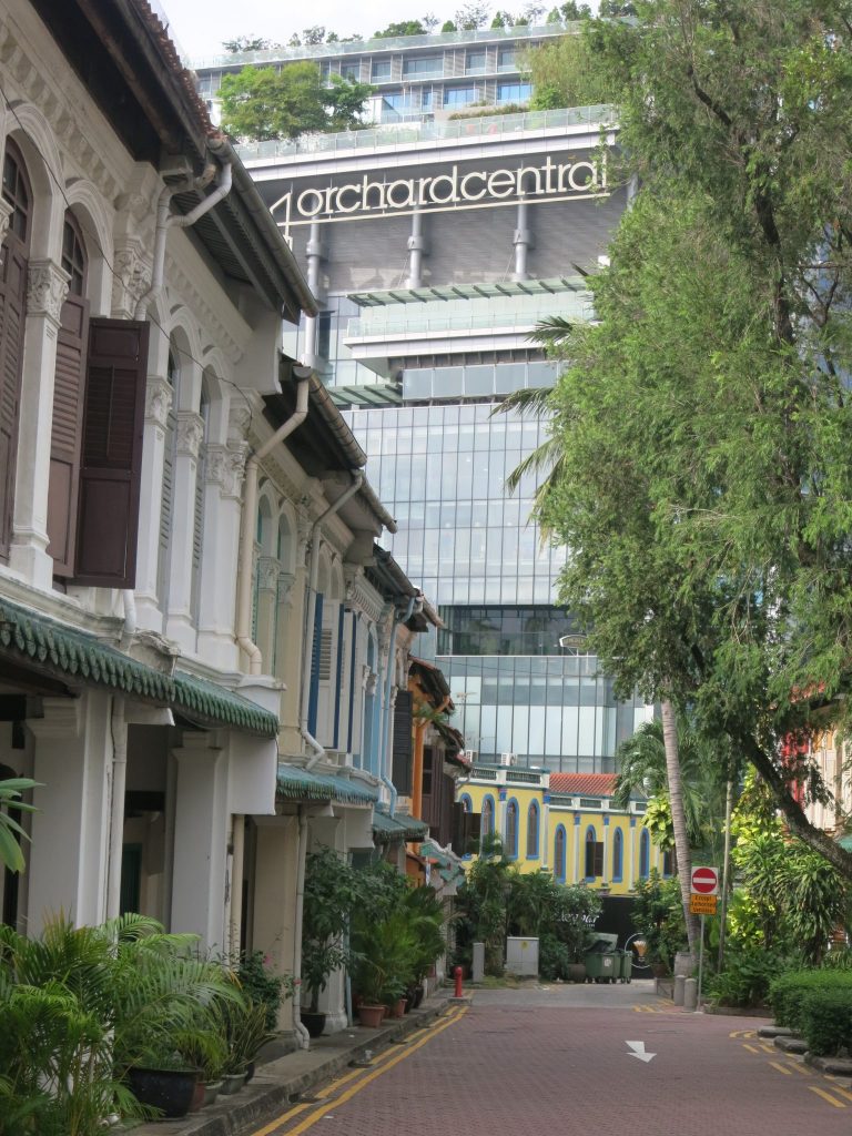 An Orchard Street mall looms over a row of colonial houses in Emerald Hill, Singapore.