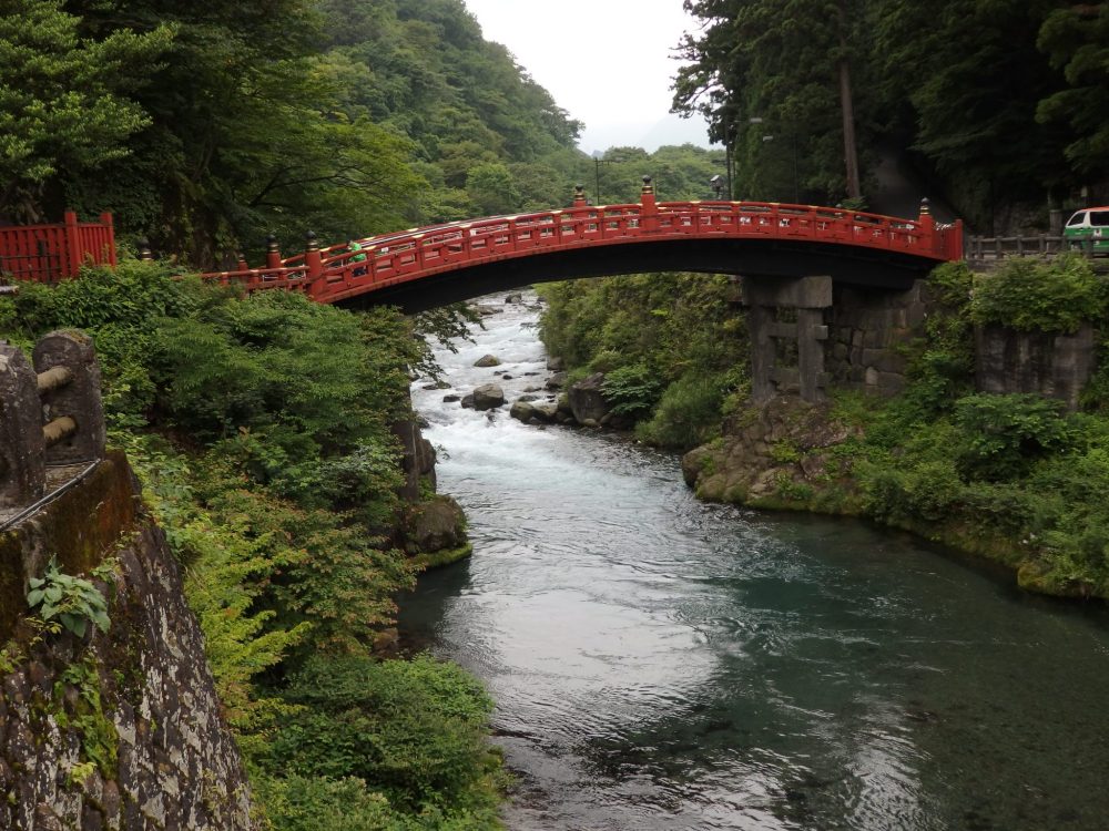 The bright red Shinkyo Sacred Bridge crosses a river in Nikko, Japan: What to see in Nikko