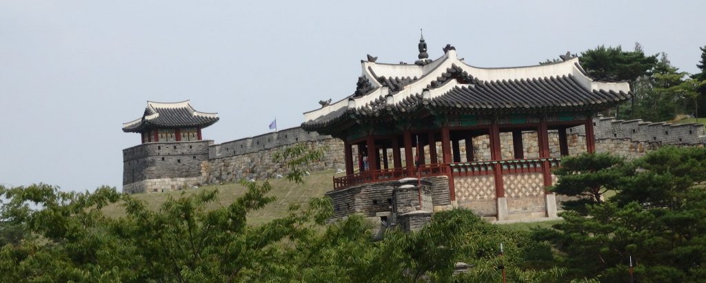 a portion of the Hwaseong Fortress wall, with two of the gates visible, in Suwon, South Korea
