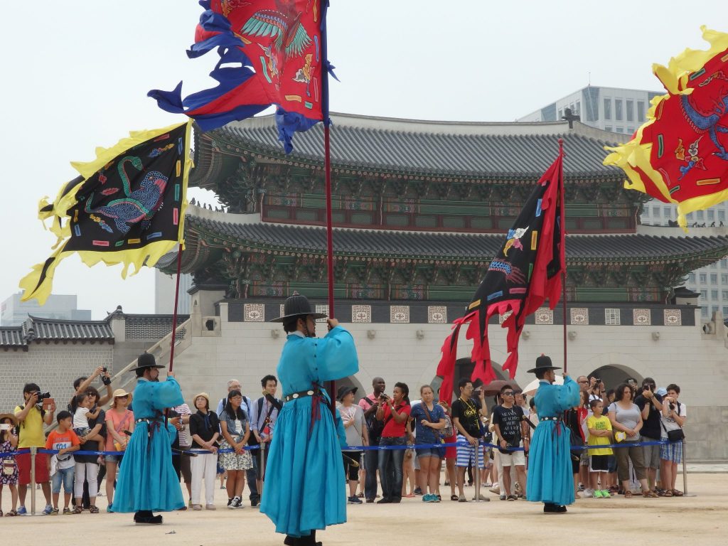 Guards carry flags during the changing of the guard ceremony at Gyeongbokgung Palace in Seoul, Korea