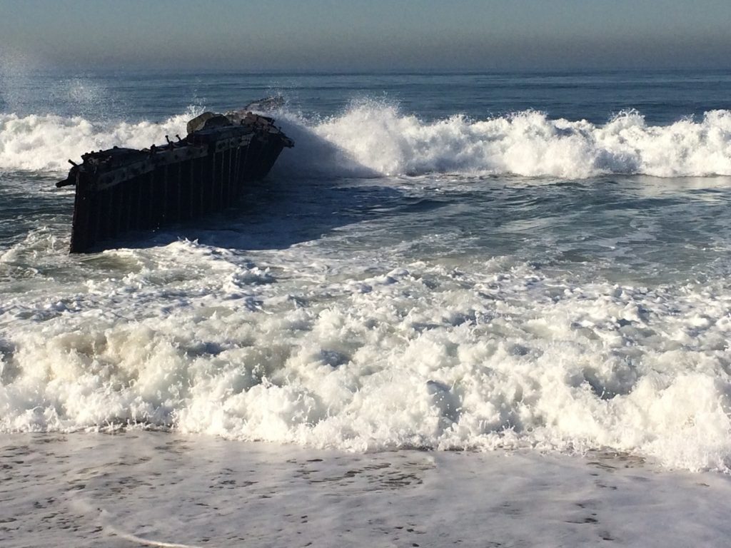waves splashing white against a rock.