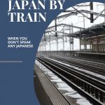 Text: Traveling Japan by train when you don't speak any Japanese. Image: View down empty train tracks as seen from a station platform.