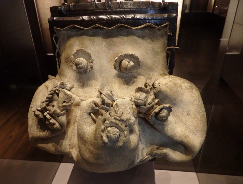 The bag is off-white leather, with strange protrusions that I think were meant to look like flowers. Instead it looks like some sort of diseased animal's face.