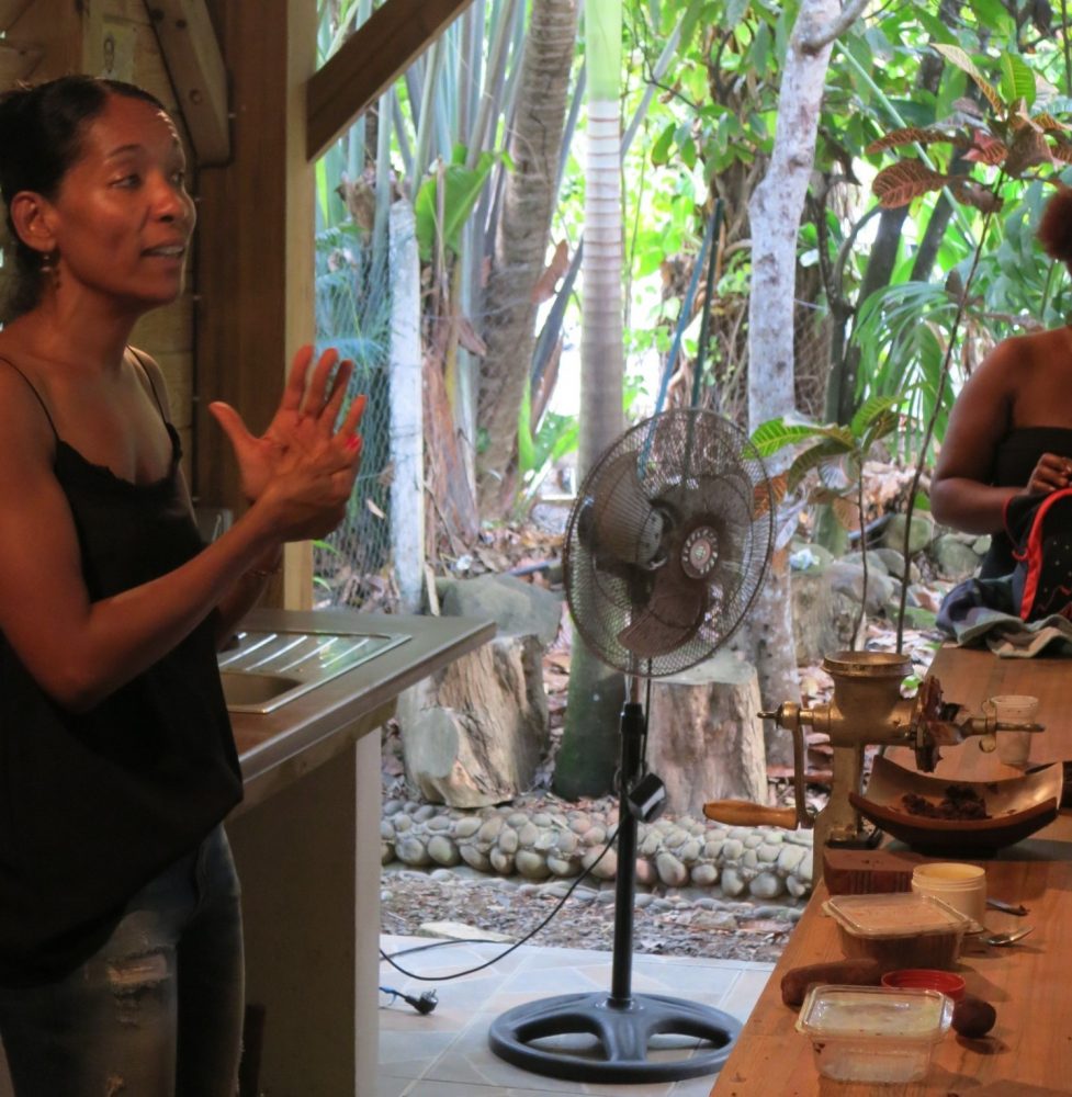 A staff member explains the chocolate-making process at La Maison du Cacao in Guadeloupe.