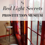 Text: Red Light Secrets Prostitution Museum. Image: large windows, chairs in front of them.