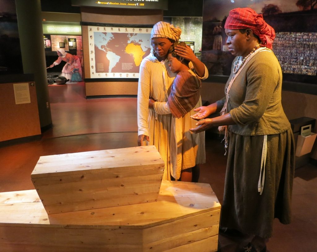 This life-size display greets visitors as they enter the museum: a representation of a funeral at the African Burial Ground.