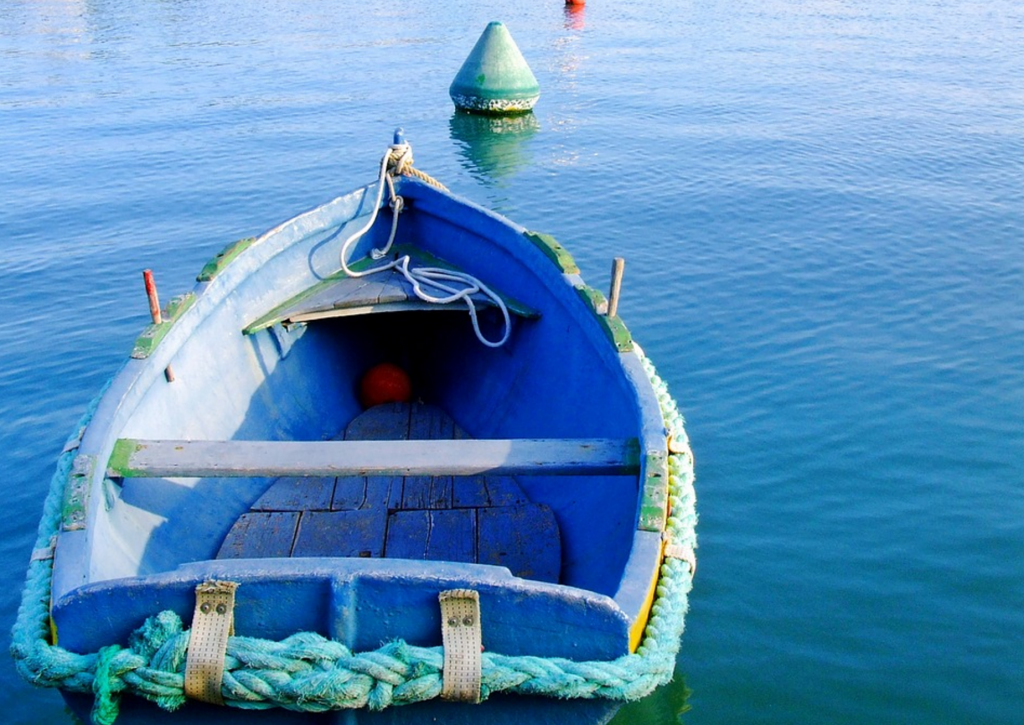 A green and blue rowboat, moored to a buoy. Somewhere in Vietnam, maybe?