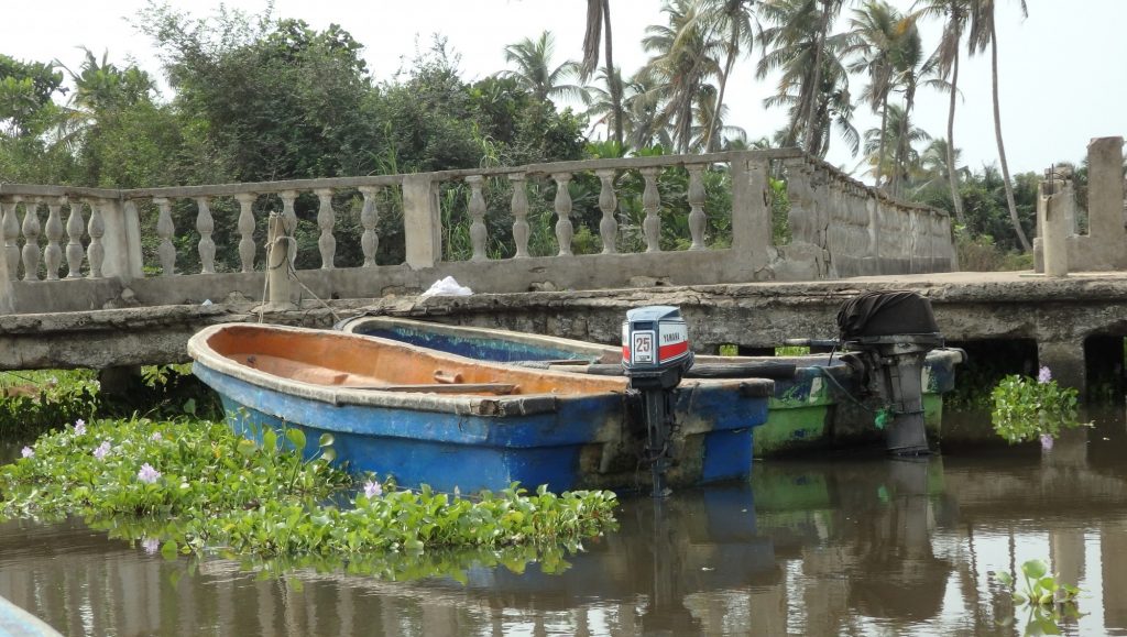 boats moored at the crumbling dock on the island off Badagry, Nigeria