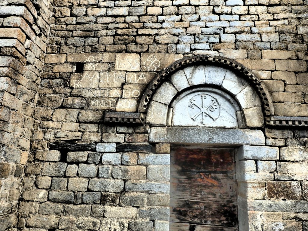 The inscription to the left of this doorway seems like it was added informally later. Santa Maria de Cap d'Aran church in Tredos, Val d'Aran, Spain