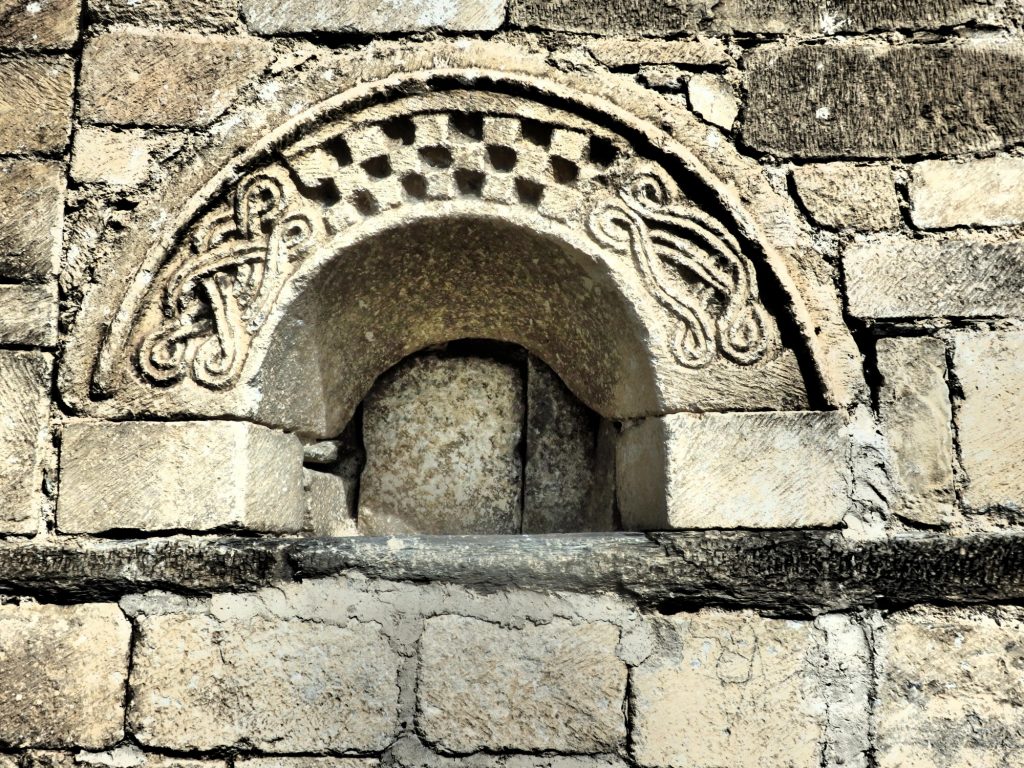 a detail carving on the church of Sant Felix in Vilac, Val d'Aran, Spain