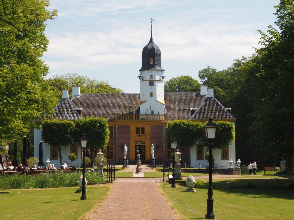 A compact and rather low building, with statuary marking its entrance and a tall off-center tower.