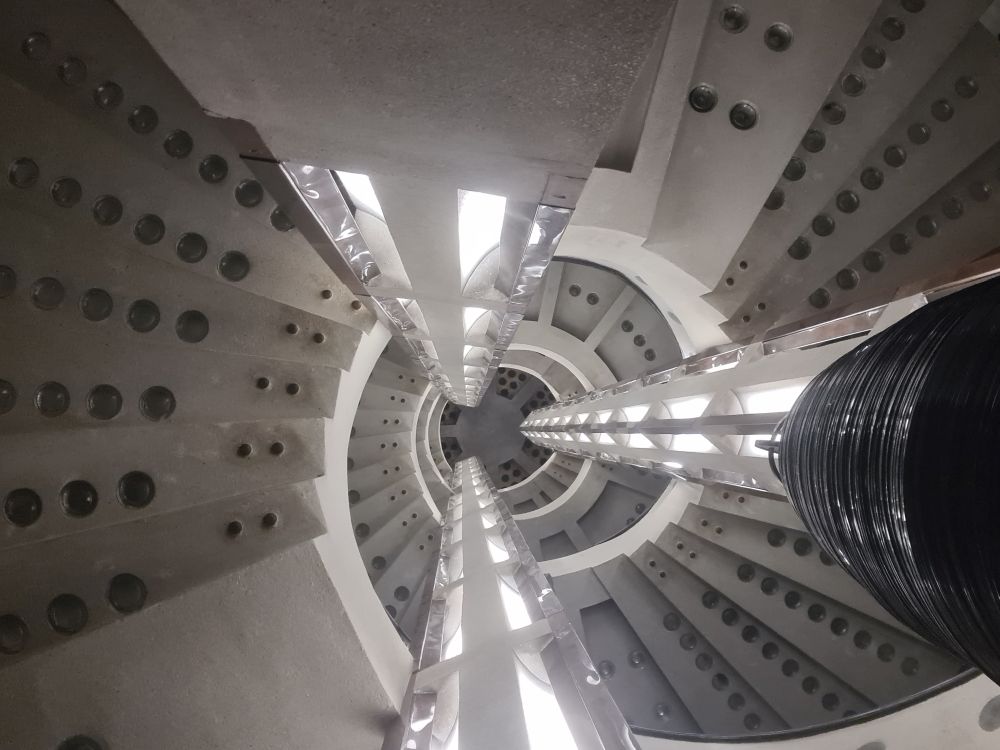 A very abstract design, with round circles of glass on each tread as it circles upward.