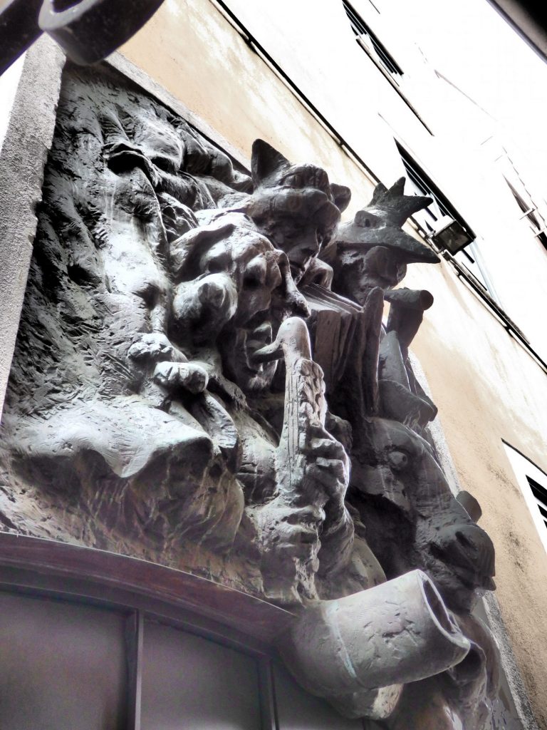 This image of the town musicians of Bremen depicts the animals as people in animal costumes playing instruments. Its in a very narrow alley in the Schnoor area.