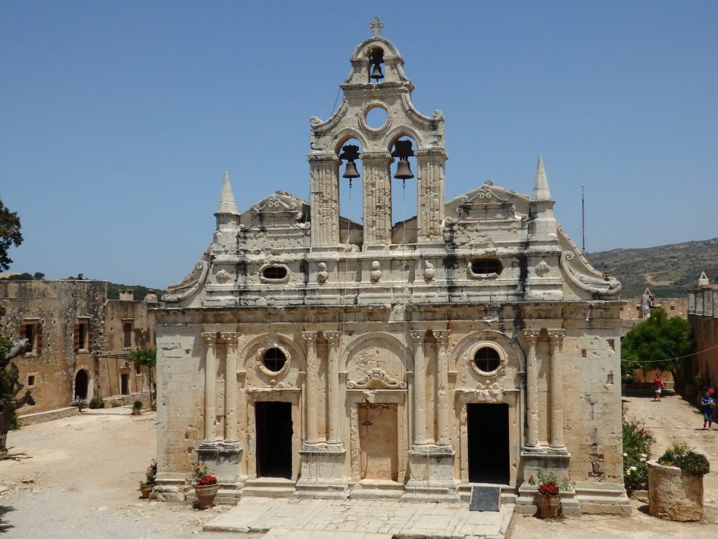 A stone church, symmetrical, quite baroque looking, but showing its age. A tower with 2 bells above the center facade.