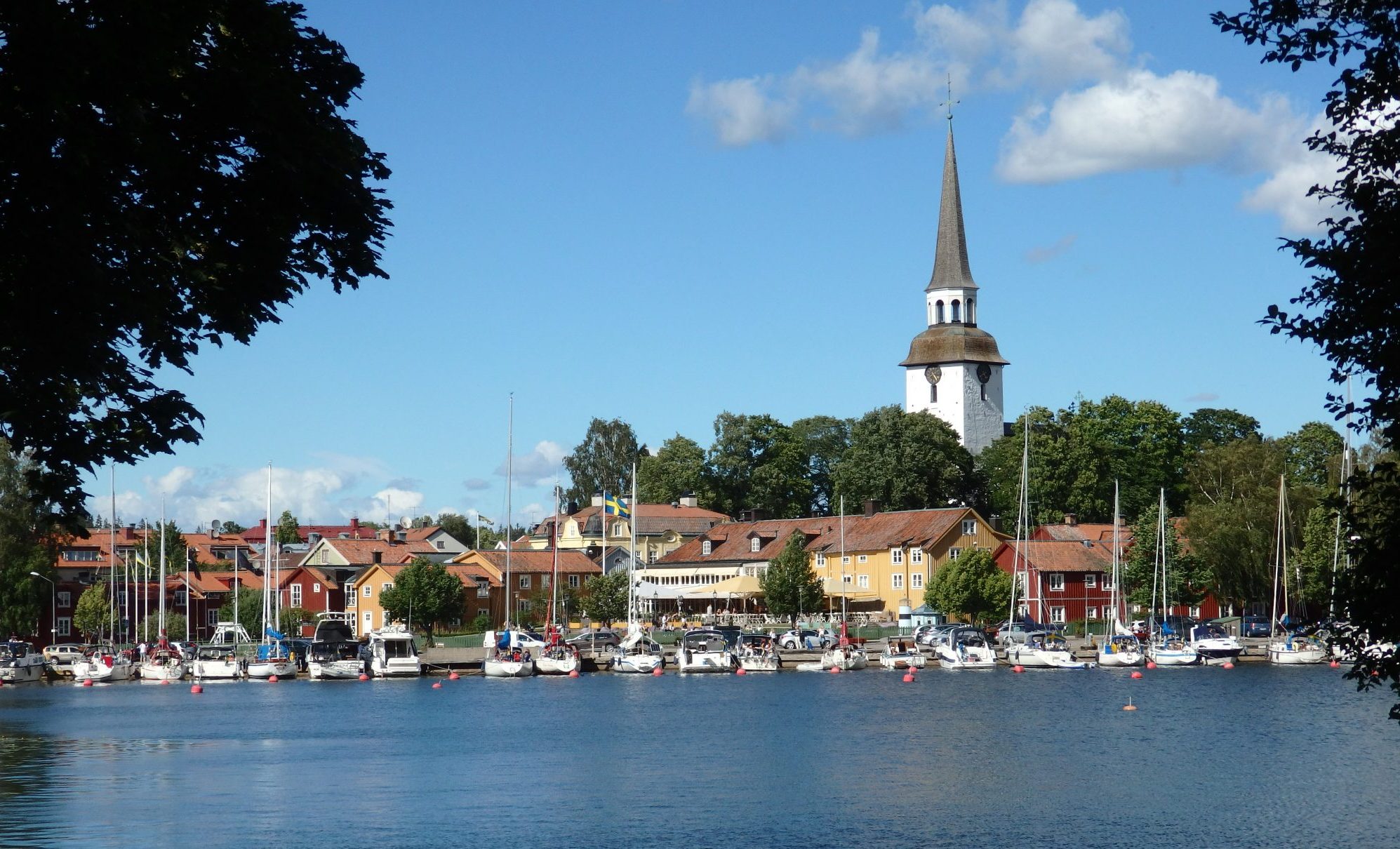 View across water to a town with a church tower.