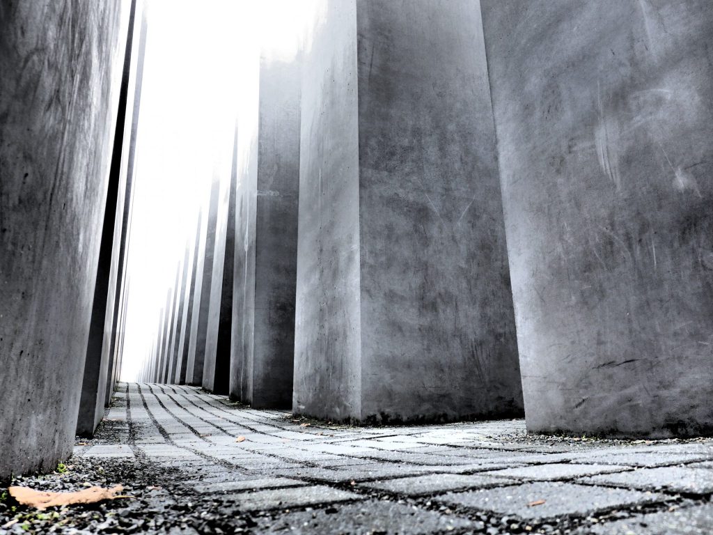 Taken from ground level, the photo sights down a row between the large cement blocks that make up the Memorial.