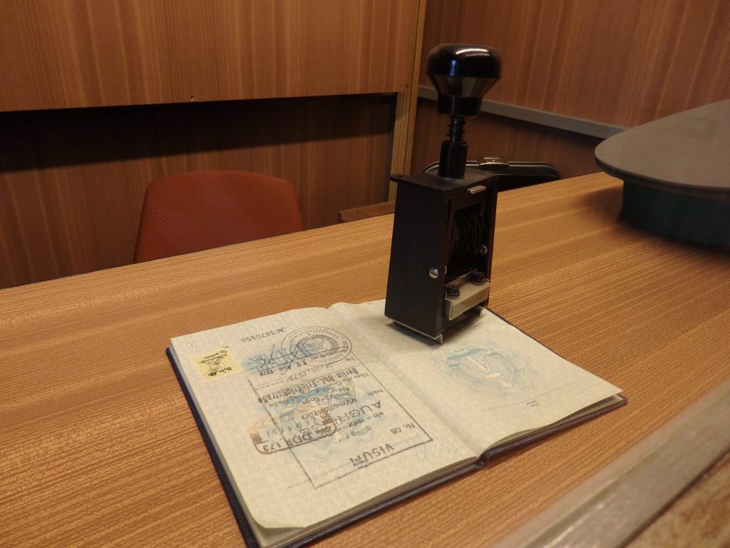 An old passport and a visa stamper.