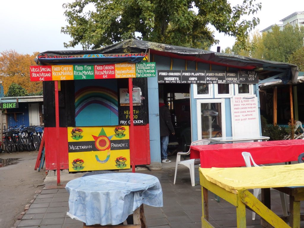 The stand is painted in bright red, yellow and green.