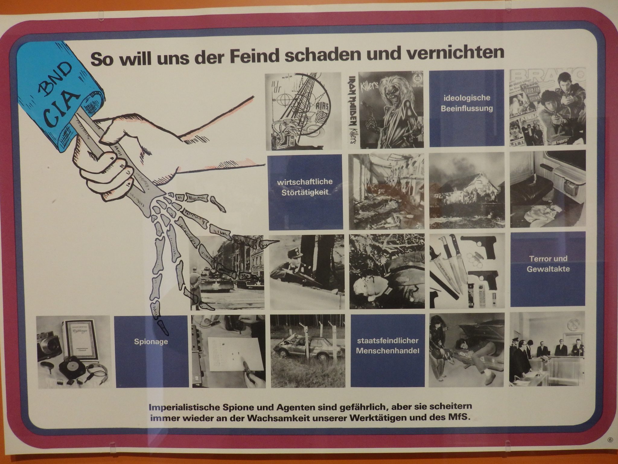 This training poster from the Stasi Museum says "This is how the enemy wants to harm and destroy us."