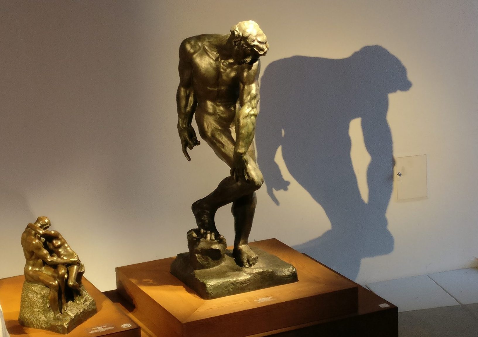 On the left, The Kiss in bronze from 1916. On the right, Adam, for The Gates of Hell, 1881, Rodin