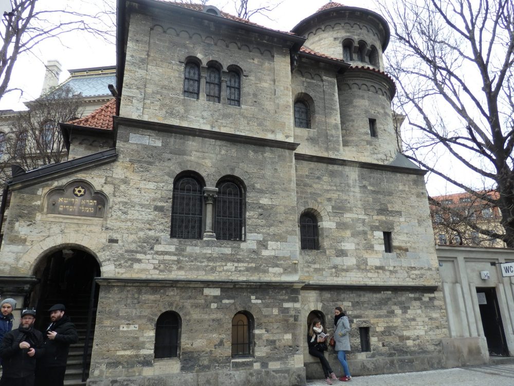 The Ceremonial Hall is right next to the Old Jewish Cemetery and on the Jewish Museum's route of the synagogues in Prague. It has three main stories and an additional small cupola in one corner. The building is made of stone bricks. The windows are small and arched. The entrance is arched as well, and is on the far left of the building. 