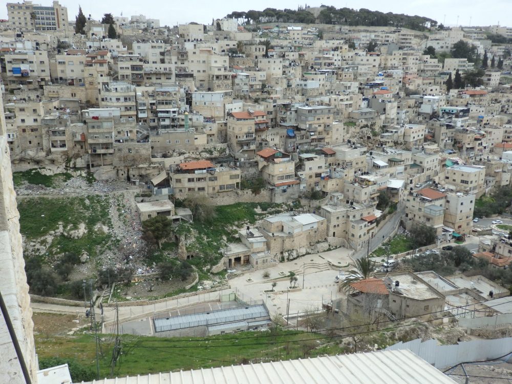 Visiting the City of David: In this view from the viewpoint, you can see the valley far below and the buildings of an Arab neighborhood across the way.