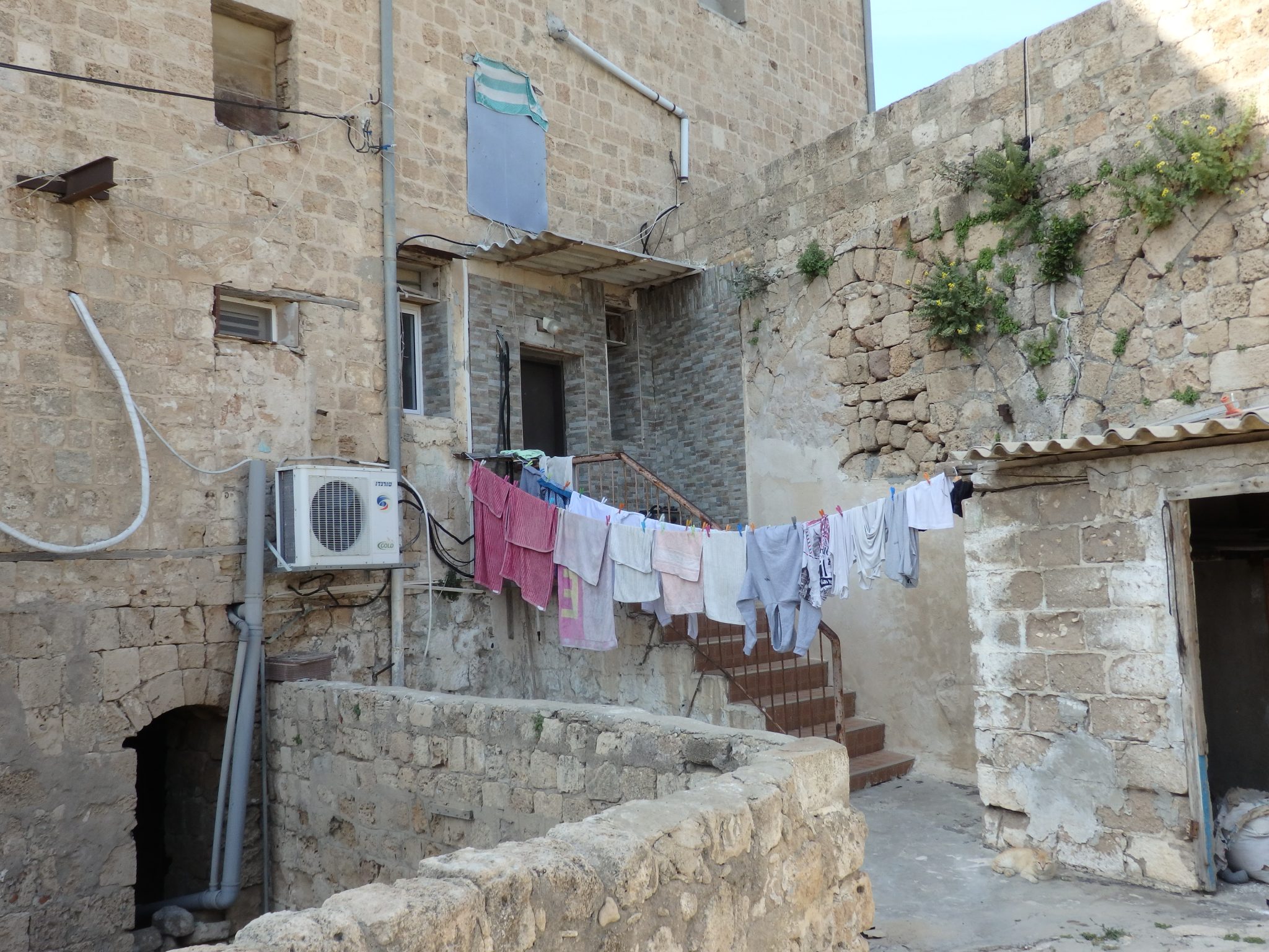 I love how the entrance to this home in Akko old city shows signs of its age: the air conditioner and the modern siding around the door contrasting with the ancient arches, still visible on the wall.
