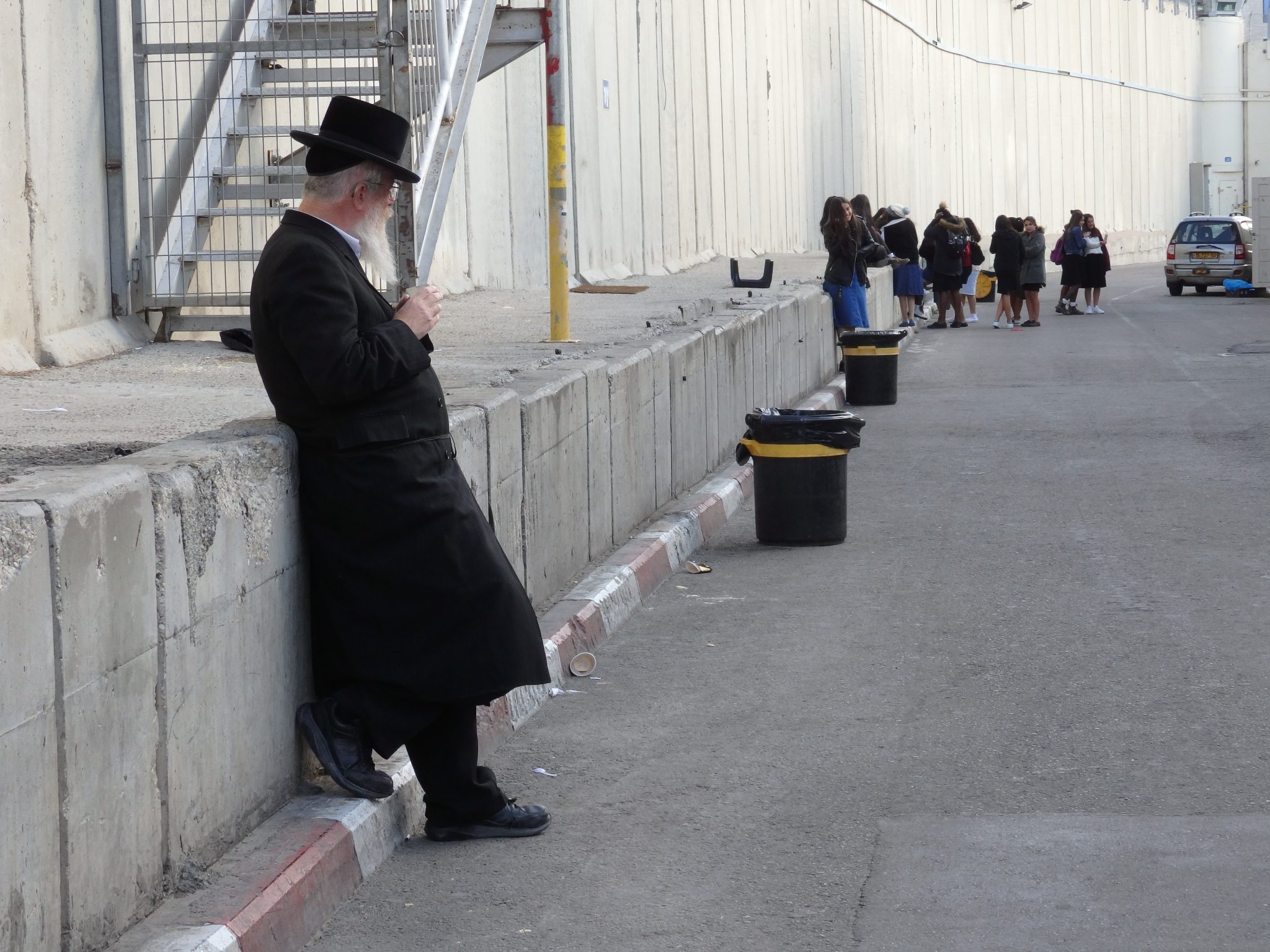 An Orthodox Jew takes a break outside Rachels Tomb