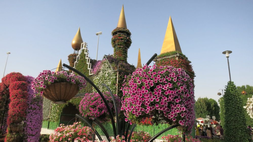 Flowers on the gateway with the mismatched towers at Dubai Miracle Garden