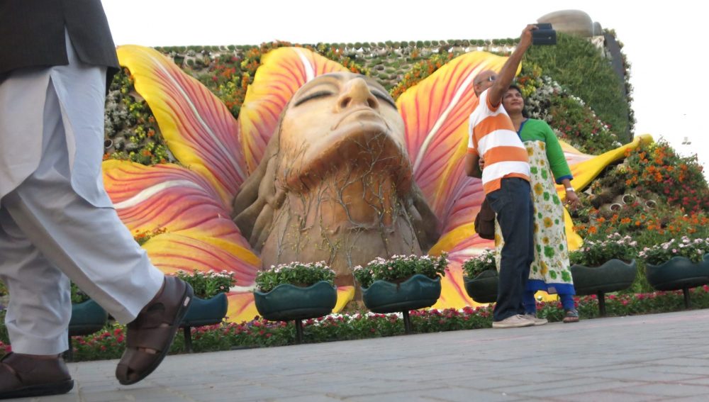 A giant male head seems to emerge from a flower in Dubai Miracle Garden.